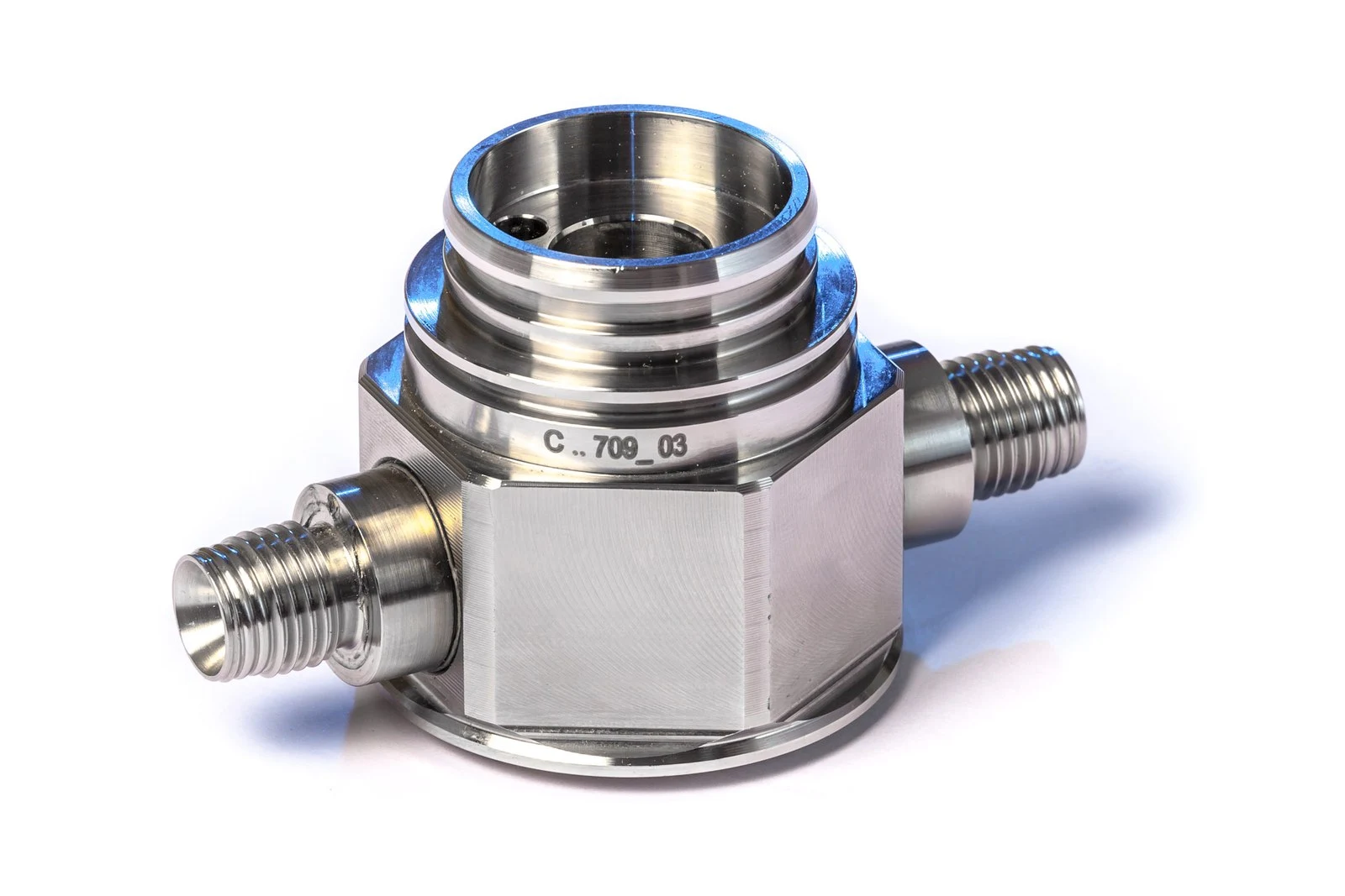 Two threaded studs projection welded to a machined stainless steel fitting.